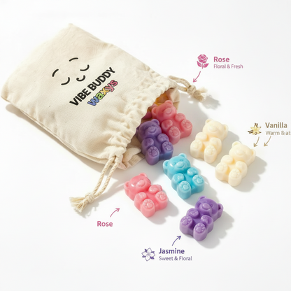 Colorful bear-shaped wax melts called nom nom's with a drawstring bag labeled 'Vibe Buddy Waxys'.